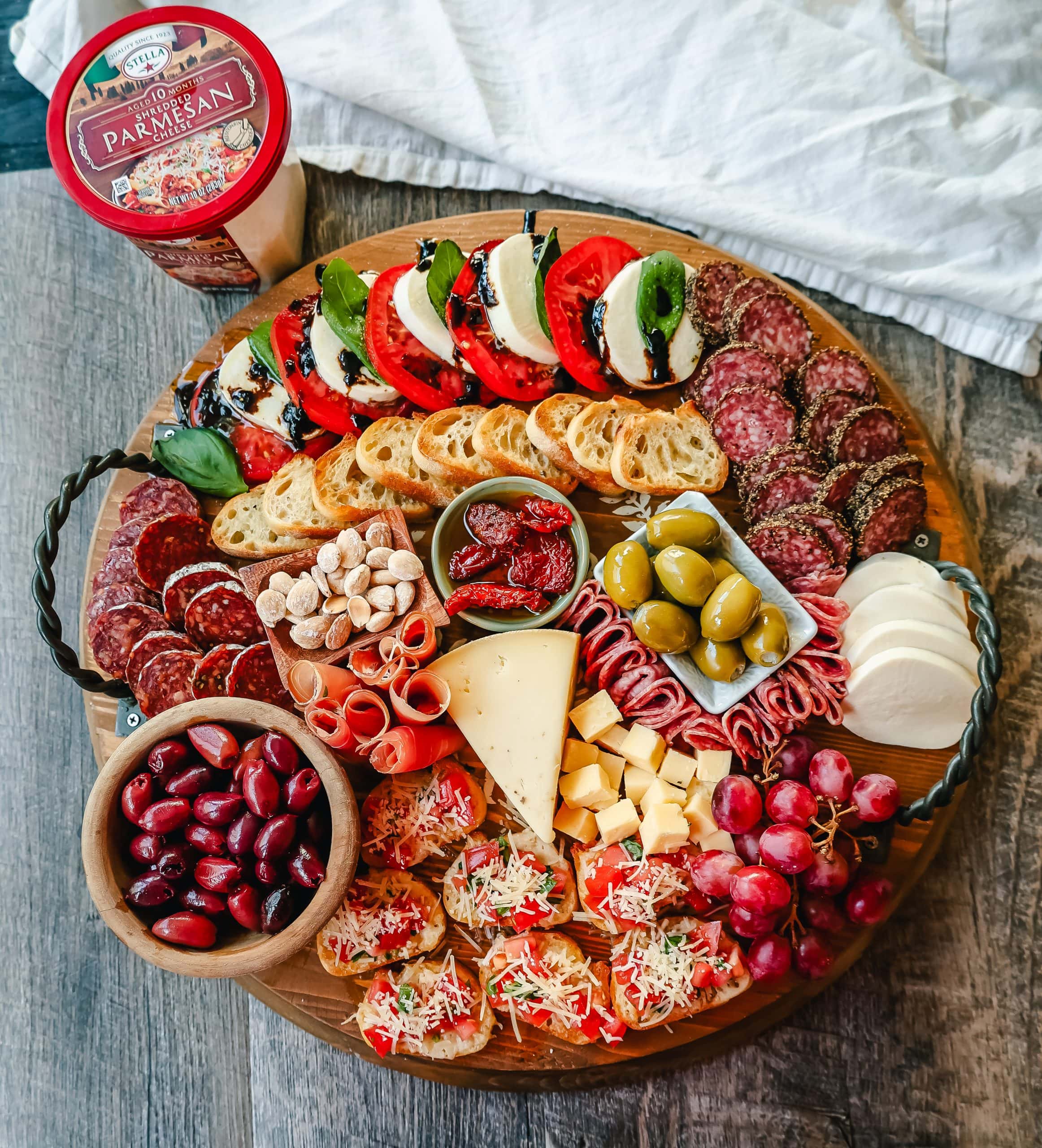 Italian Charcuterie Board. A beautiful Italian Charcuterie board filled with Italian meats and cheeses and paired with sauces, fruits, and vegetables. Perfect to pair with your Italian meal.