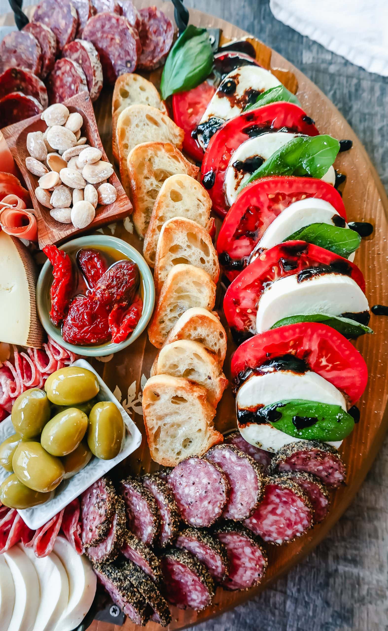 Italian Charcuterie Board. A beautiful Italian Charcuterie board filled with Italian meats and cheeses and paired with sauces, fruits, and vegetables. Perfect to pair with your Italian meal.