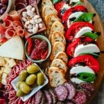 Italian Charcuterie Board. A beautiful Italian Charcuterie board filled with Italian meats and cheeses and paired with sauces, fruits, and vegetables. Perfect to pair with your Italian meal.