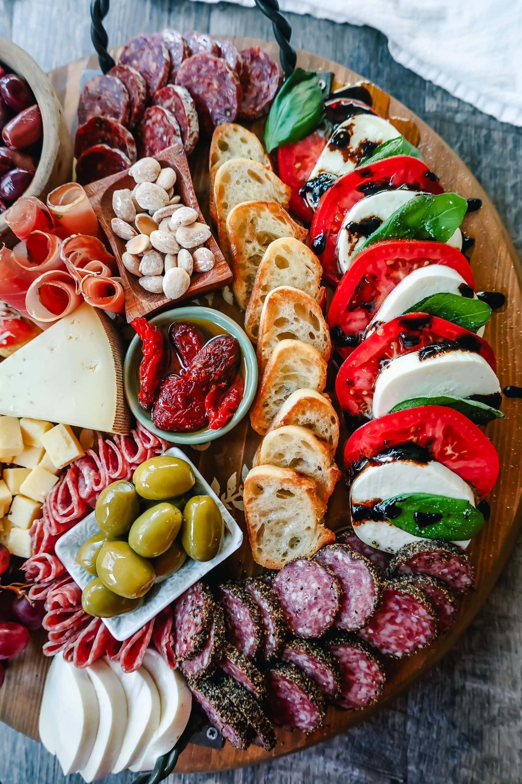 Italian Charcuterie Board. A beautiful Italian Charcuterie board filled with Italian meats and cheeses and paired with sauces, fruits, and vegetables. Perfect to pair with your Italian meal.