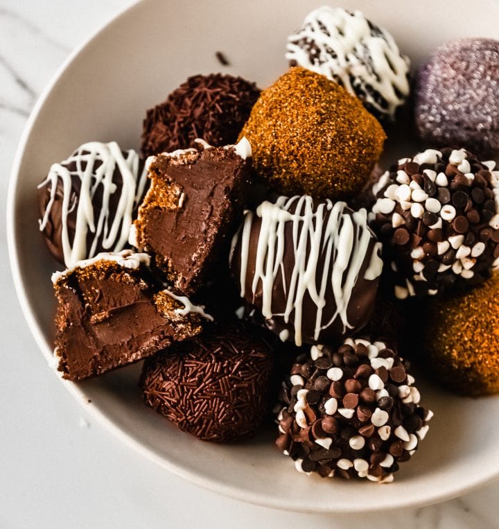 Chocolate Truffles. Rich, creamy, decadent homemade chocolate truffles made with high-quality chocolate, heavy cream, and a touch of butter rolled into your favorite toppings.