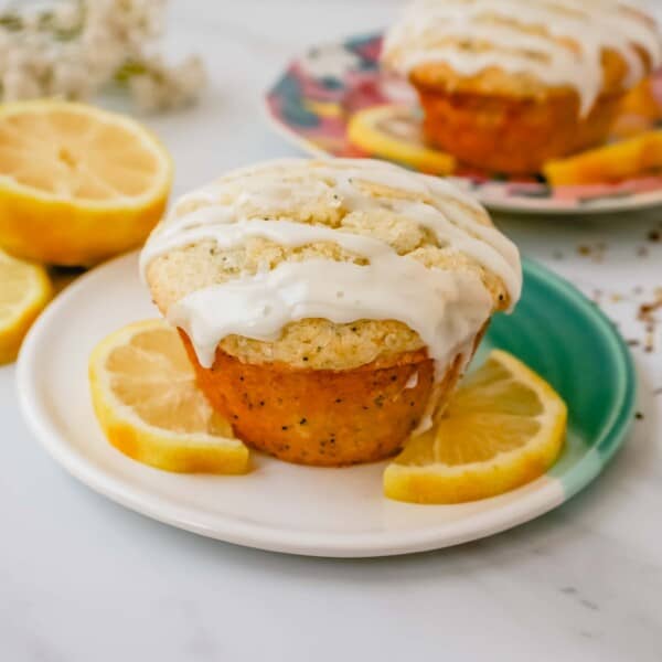 The most tender, moist, light, fluffy, and tangy lemon poppyseed muffins with a sweet lemon glaze. The best lemon poppyseed muffin recipe!