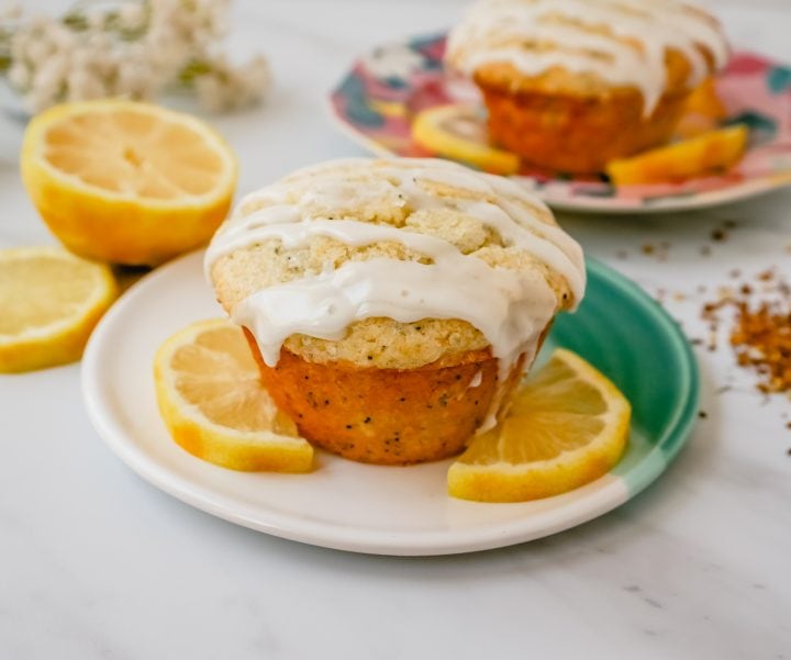The most tender, moist, light, fluffy, and tangy lemon poppyseed muffins with a sweet lemon glaze. The best lemon poppyseed muffin recipe!