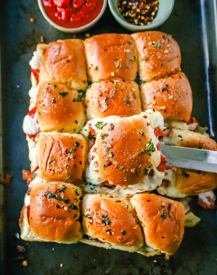 Pizza Sliders. Hawaiian Rolls Pizza Sliders made with Pepperoni, Mozzarella Cheese, and Provolone Cheese baked inside of soft, sweet rolls topped with warmed garlic butter and dipped in marinara sauce. The perfect party food! 