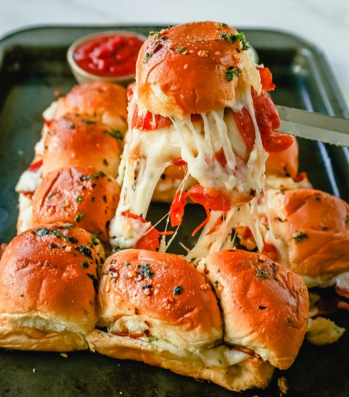 Pizza Sliders. Hawaiian Rolls Pizza Sliders made with Pepperoni, Mozzarella Cheese, and Provolone Cheese baked inside of soft, sweet rolls topped with warmed garlic butter and dipped in marinara sauce. The perfect party food! 