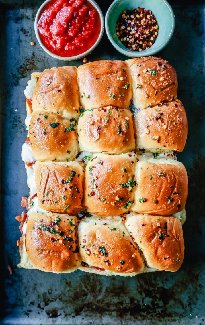 Pizza Sliders. Hawaiian Rolls Pizza Sliders made with Pepperoni, Mozzarella Cheese, and Provolone Cheese baked inside of soft, sweet rolls topped with warmed garlic butter and dipped in marinara sauce. The perfect party food! 