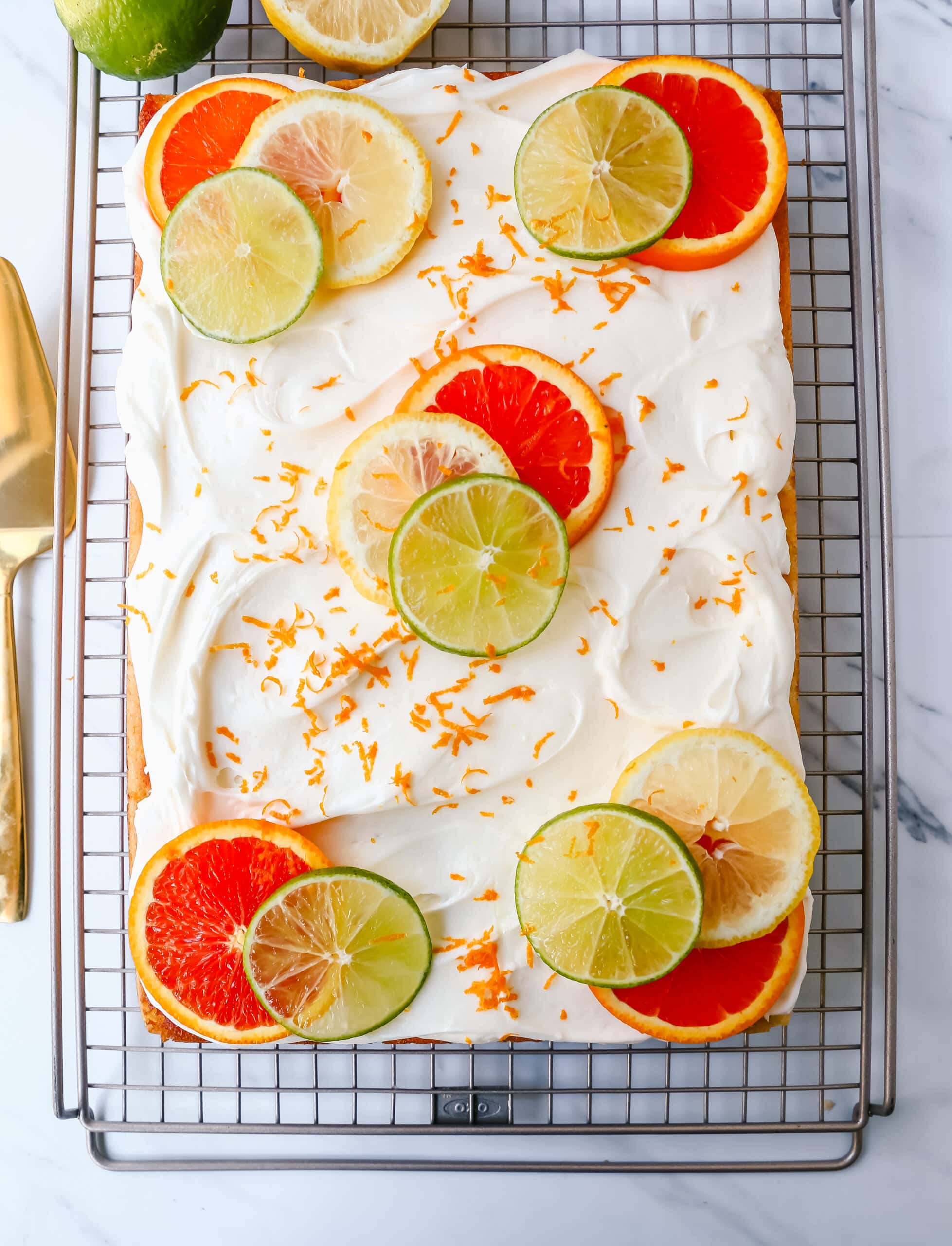 Citrus Sheet Cake made with fresh-squeezed orange, lemon, and lime juices in a moist, fluffy cake and topped with a creamy and silky homemade cream cheese frosting and topped with citrus slices. A beautiful Spring and Summer celebration cake! 