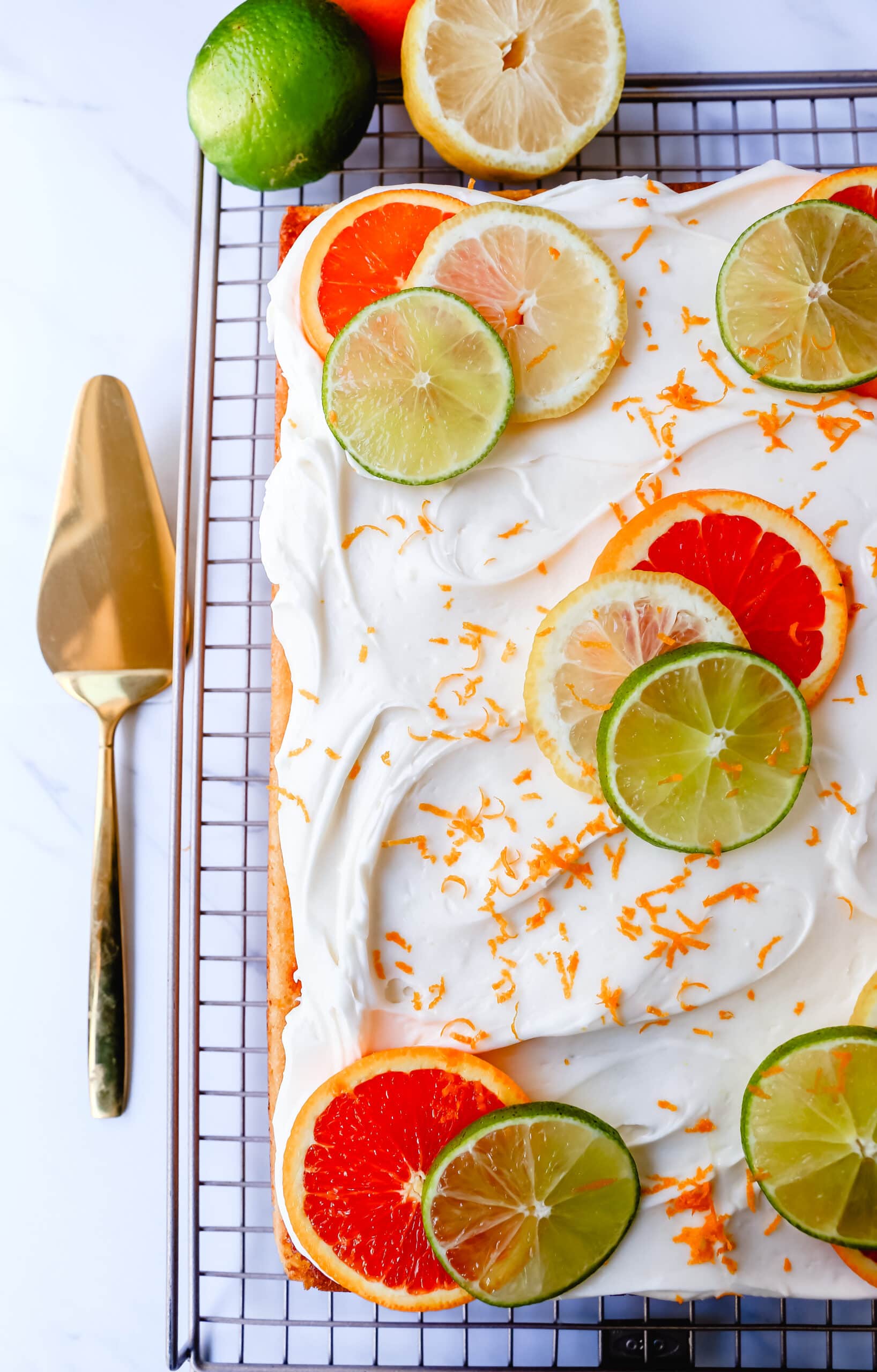 Citrus Sheet Cake made with fresh-squeezed orange, lemon, and lime juices in a moist, fluffy cake and topped with a creamy and silky homemade cream cheese frosting and topped with citrus slices. A beautiful Spring and Summer celebration cake! 