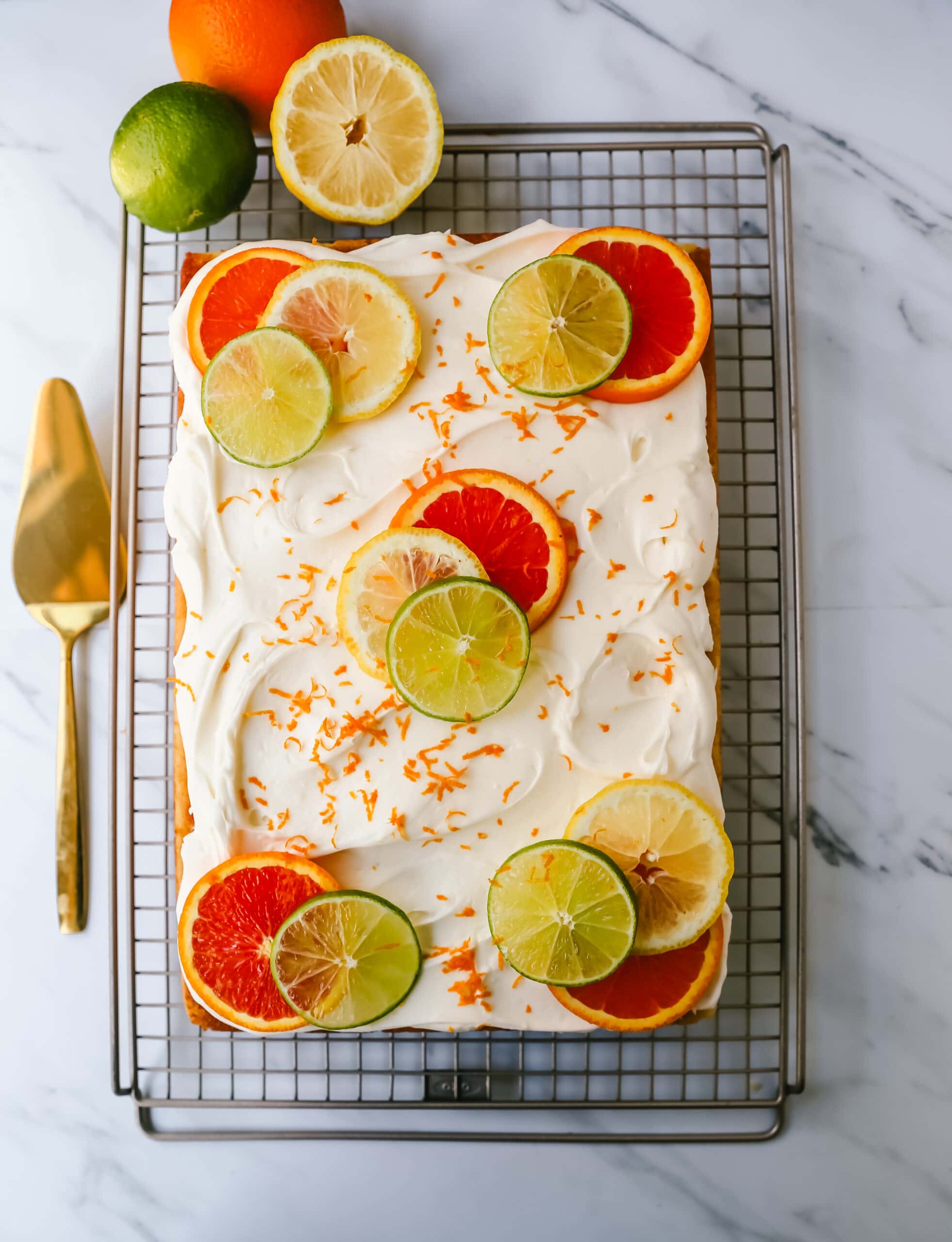 Citrus Sheet Cake made with fresh-squeezed orange, lemon, and lime juices in a moist, fluffy cake and topped with a creamy and silky homemade cream cheese frosting and topped with citrus slices. A beautiful Spring and Summer celebration cake! 