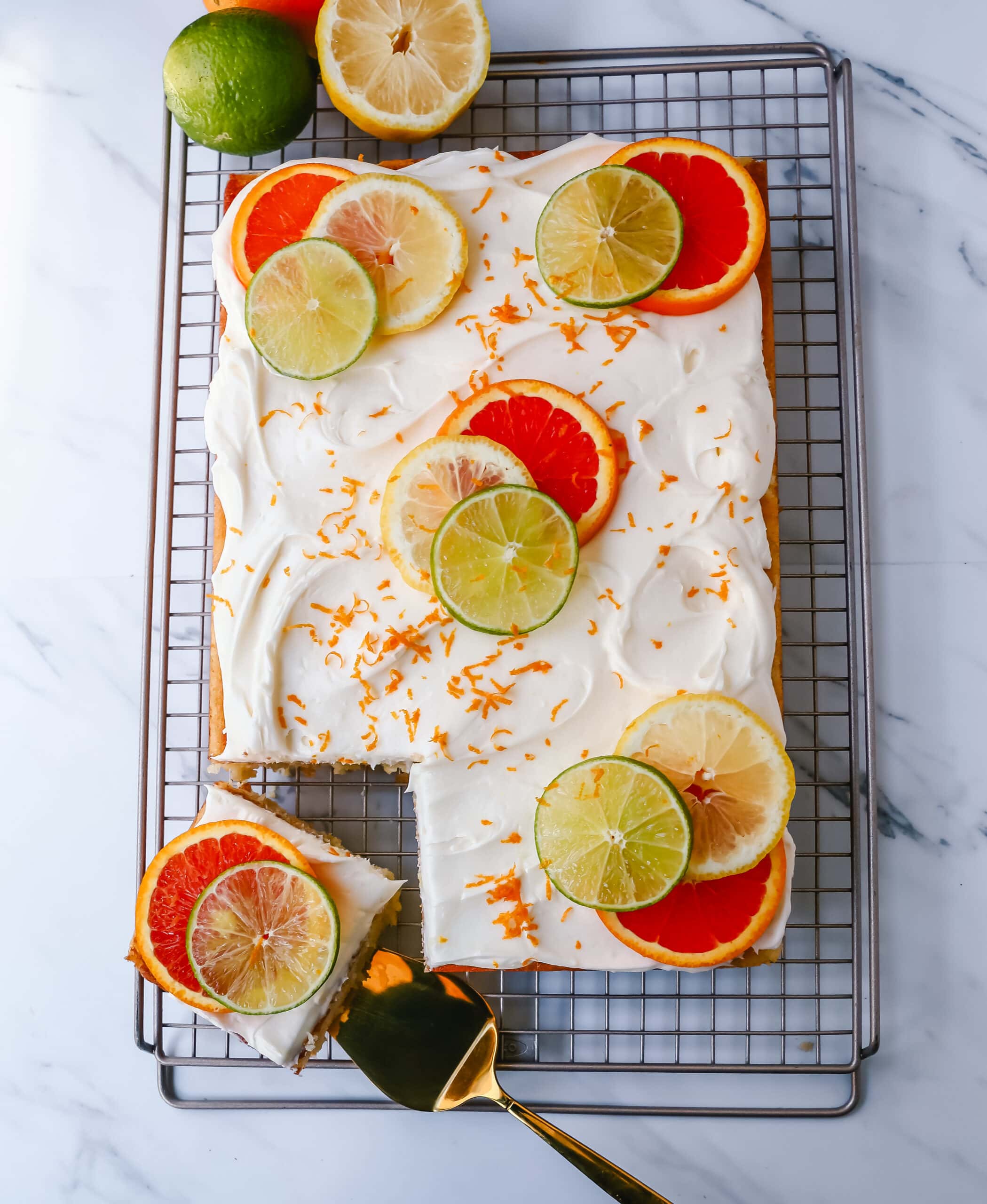 Citrus Sheet Cake made with fresh-squeezed orange, lemon, and lime juices in a moist, fluffy cake and topped with a creamy and silky homemade cream cheese frosting and topped with citrus slices. A beautiful Spring and Summer celebration cake! 