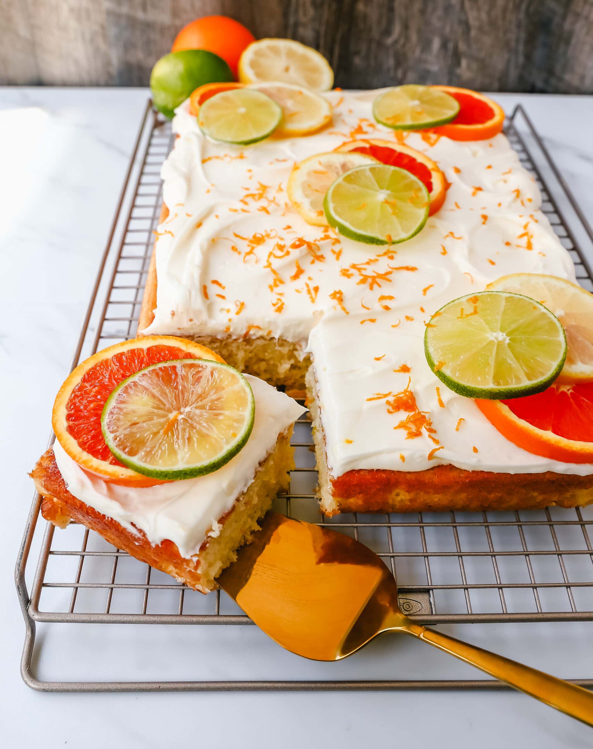 Citrus Sheet Cake made with fresh-squeezed orange, lemon, and lime juices in a moist, fluffy cake and topped with a creamy and silky homemade cream cheese frosting and topped with citrus slices. A beautiful Spring and Summer celebration cake! 