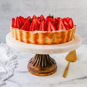 This Strawberry Cream Cheese Tart is made with a buttery tart crust, sweet vanilla cream cheese filling, and fresh strawberries with a shiny glaze. The perfect easy Summer strawberry dessert.