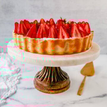 This Strawberry Cream Cheese Tart is made with a buttery tart crust, sweet vanilla cream cheese filling, and fresh strawberries with a shiny glaze. The perfect easy Summer strawberry dessert.