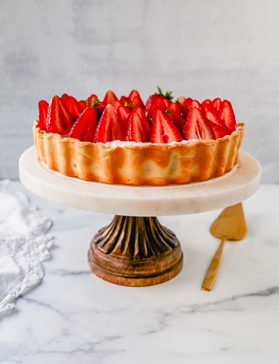 This Strawberry Cream Cheese Tart is made with a buttery tart crust, sweet vanilla cream cheese filling, and fresh strawberries with a shiny glaze. The perfect easy Summer strawberry dessert.