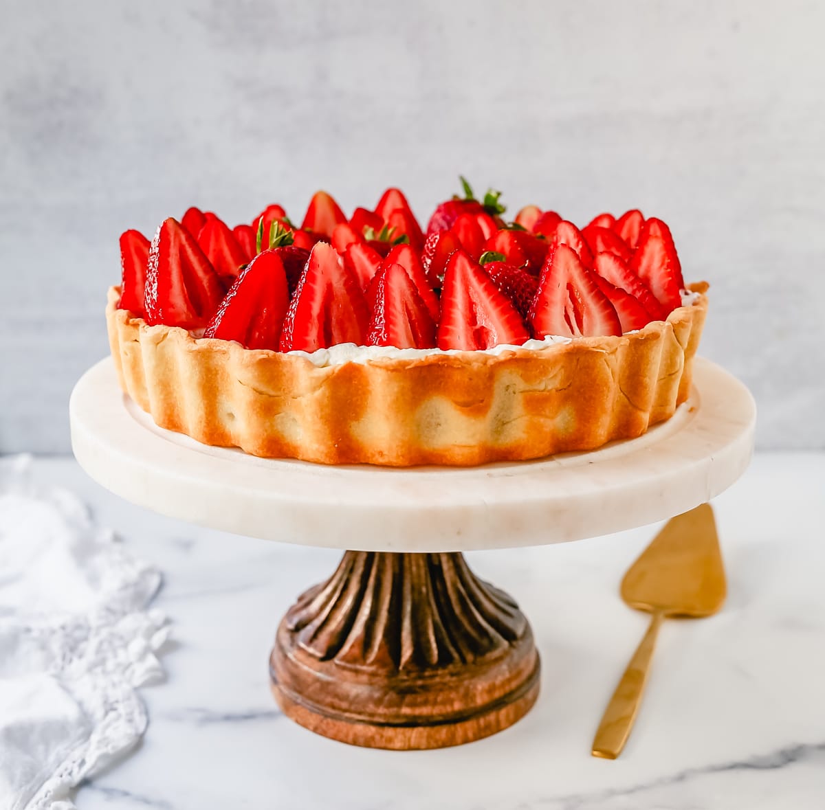 This Strawberry Cream Cheese Tart is made with a buttery tart crust, sweet vanilla cream cheese filling, and fresh strawberries with a shiny glaze. The perfect easy Summer strawberry dessert.