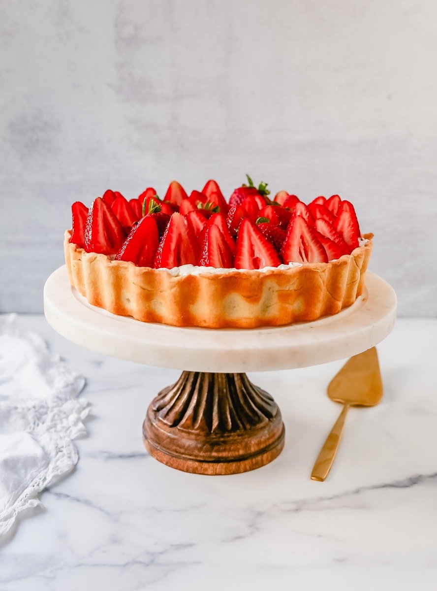 This Strawberry Cream Cheese Tart is made with a buttery tart crust, sweet vanilla cream cheese filling, and fresh strawberries with a shiny glaze. The perfect easy Summer strawberry dessert.