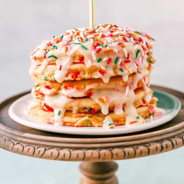 Light, Fluffy Buttermilk Pancakes with Sprinkles and topped with a Cream Cheese Glaze. The perfect Birthday Pancakes Recipe! A knock-off of the famous IHOP's Cupcake Pancakes.