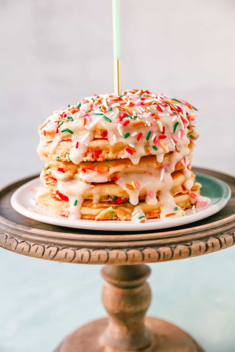 Light, Fluffy Buttermilk Pancakes with Sprinkles and topped with a Cream Cheese Glaze. The perfect Birthday Pancakes Recipe! A knock-off of the famous IHOP's Cupcake Pancakes.