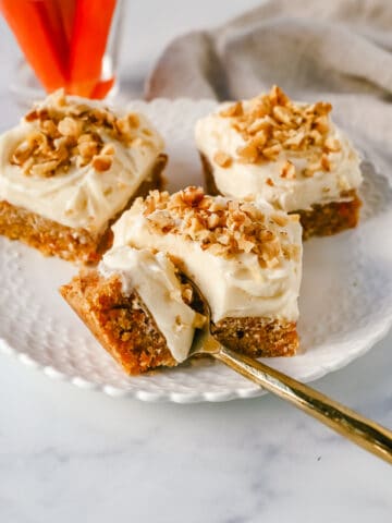 These soft, chewy carrot cake bars with cream cheese frosting are perfect for your Spring gathering. These carrot cake blondies taste even better than carrot cake!