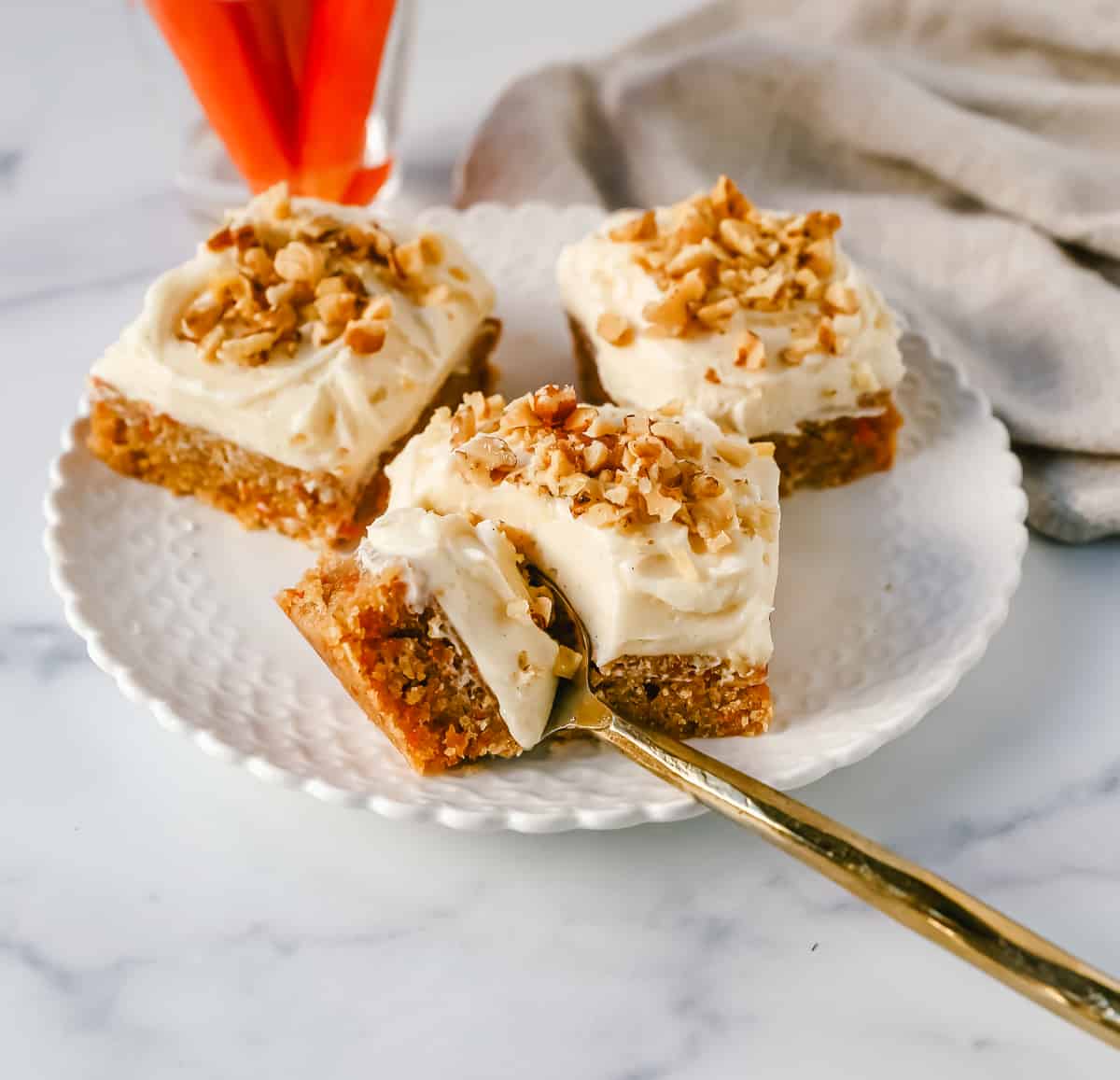 These soft, chewy carrot cake bars with cream cheese frosting are perfect for your Spring gathering. These carrot cake blondies taste even better than carrot cake!