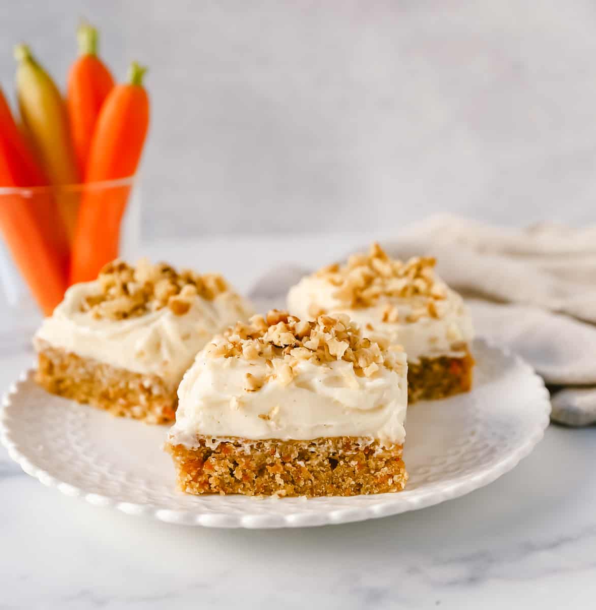 These soft, chewy carrot cake bars with cream cheese frosting are perfect for your Spring gathering. These carrot cake blondies taste even better than carrot cake!