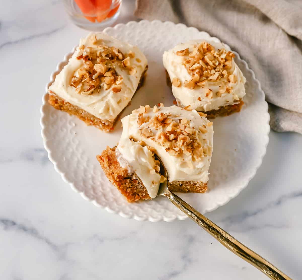 These soft, chewy carrot cake bars with cream cheese frosting are perfect for your Spring gathering. These carrot cake blondies taste even better than carrot cake!