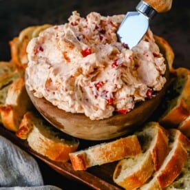 This pimento cheese dip is famous in the South for good reason. This pimento dip is made with cream cheese, mayonnaise, two types of cheddar cheeses, chopped pimentos, cayenne pepper, and a touch of salt.