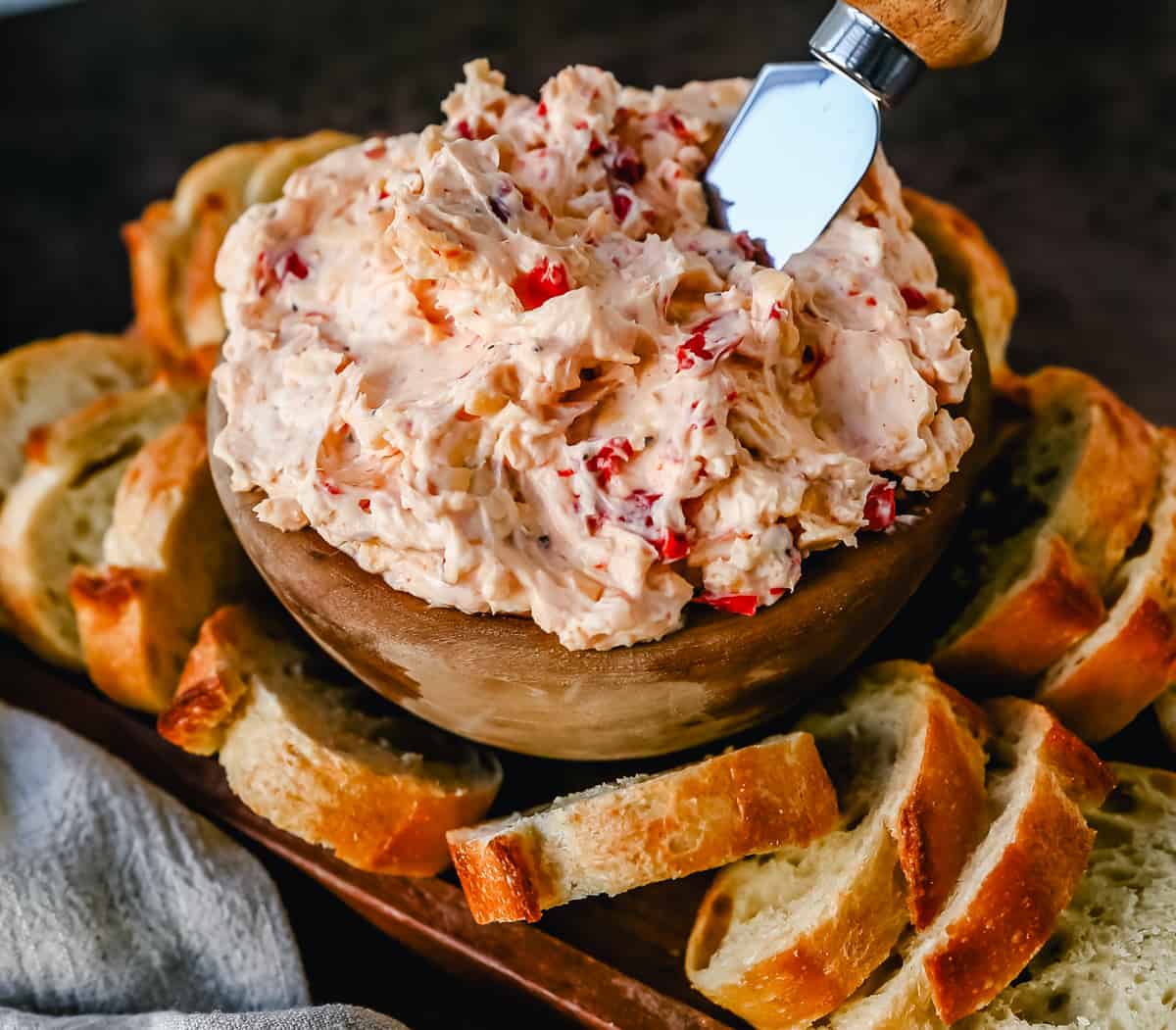 This pimento cheese dip is famous in the South for good reason. This pimento dip is made with cream cheese, mayonnaise, two types of cheddar cheeses, chopped pimentos, cayenne pepper, and a touch of salt. 