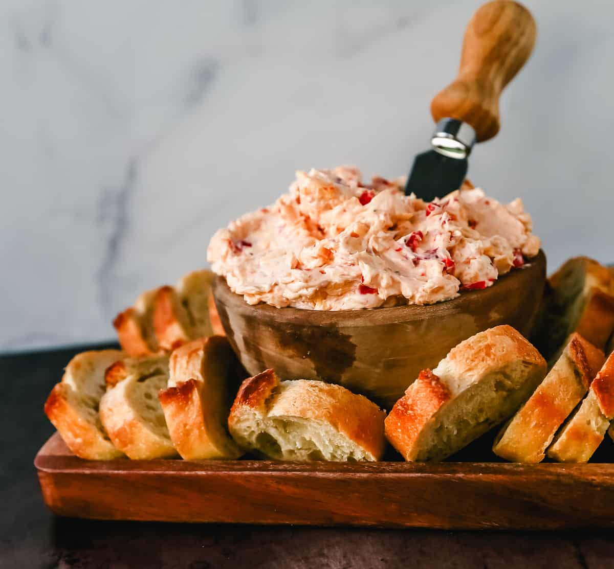 This pimento cheese dip is famous in the South for good reason. This pimento dip is made with cream cheese, mayonnaise, two types of cheddar cheeses, chopped pimentos, cayenne pepper, and a touch of salt. 