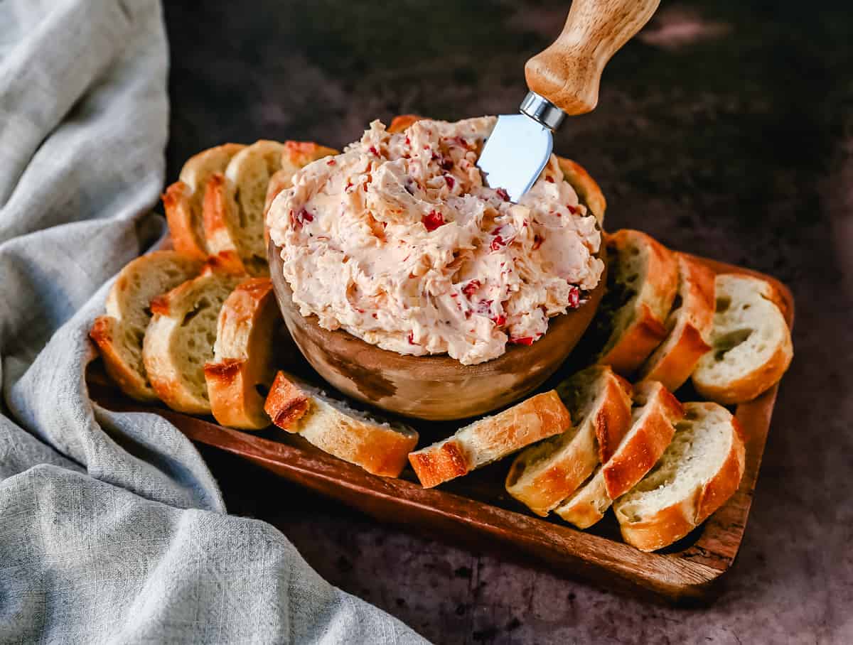 This pimento cheese dip is famous in the South for good reason. This pimento dip is made with cream cheese, mayonnaise, two types of cheddar cheeses, chopped pimentos, cayenne pepper, and a touch of salt. 