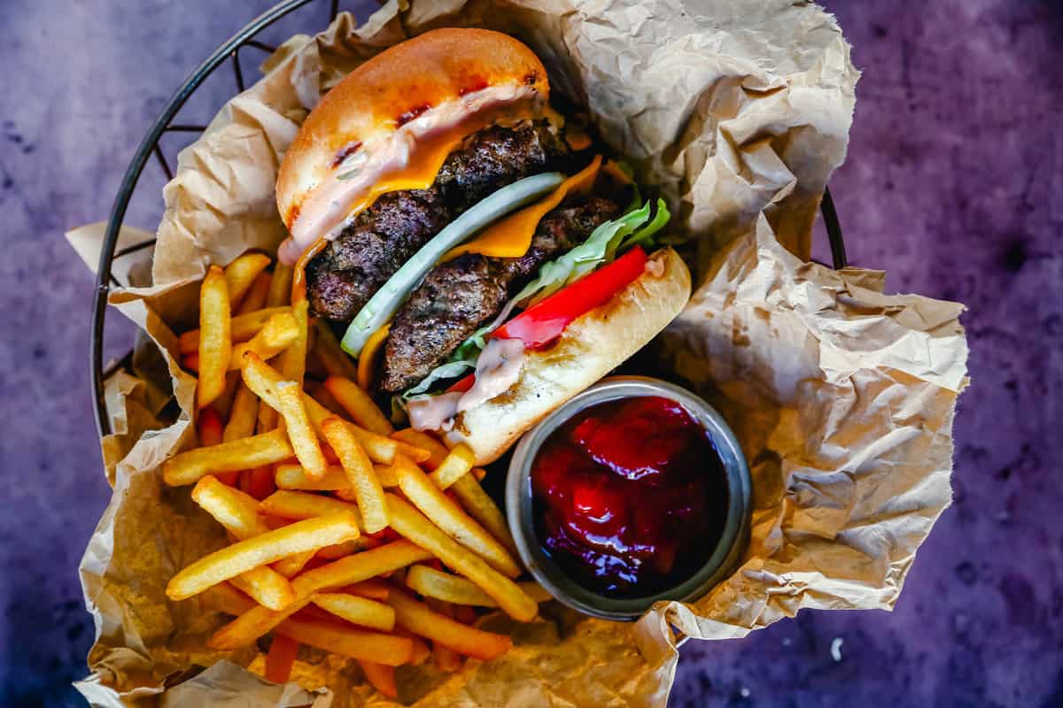 Classic All-American Cheeseburger with Cheddar Cheese and topped with burger sauce, lettuce, tomatoes, and onion. How to make the best homemade grilled cheeseburger...just like the In-N-Out Double-Double!