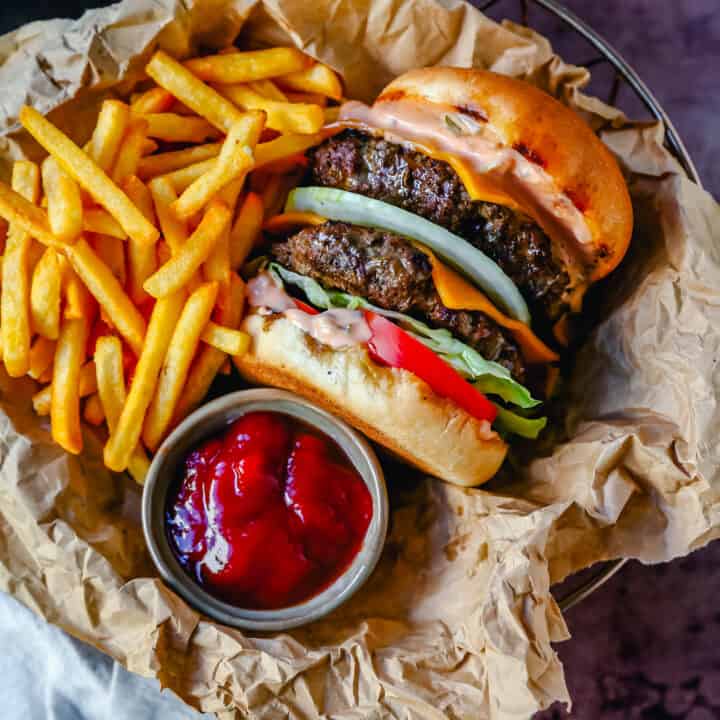 Classic All-American Cheeseburger with Cheddar Cheese and topped with burger sauce, lettuce, tomatoes, and onion. How to make the best homemade grilled cheeseburger...just like the In-N-Out Double-Double!