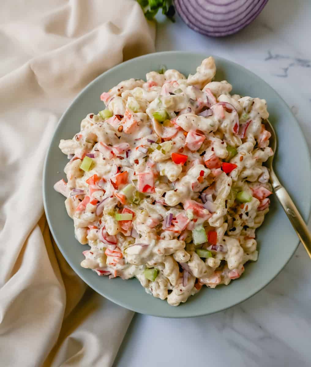 The best creamy macaroni salad recipe made with pasta, vegetables, and a creamy homemade sweet and tangy dressing. An easy, traditional macaroni salad recipe!