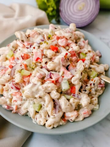 The best creamy macaroni salad recipe made with pasta, vegetables, and a creamy homemade sweet and tangy dressing. An easy, traditional macaroni salad recipe!