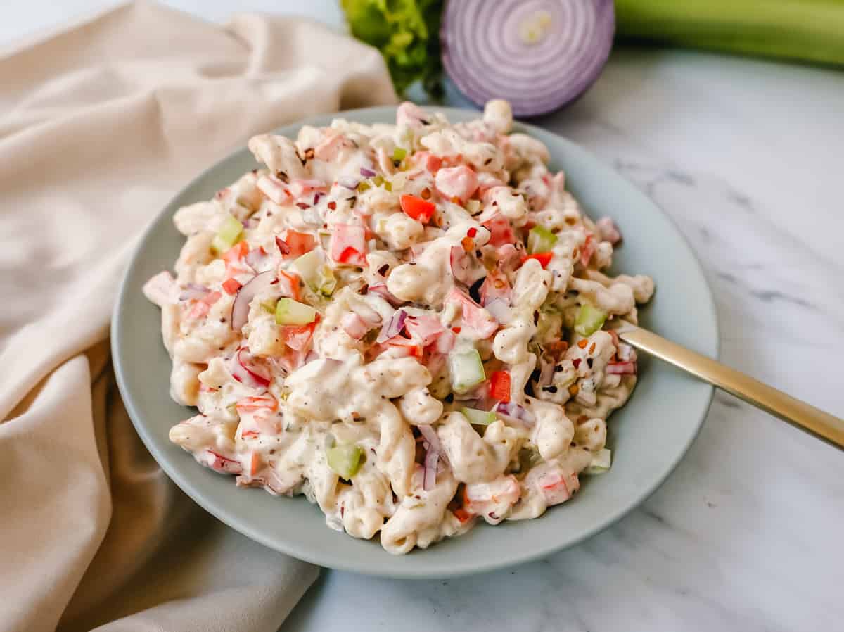 The best creamy macaroni salad recipe made with pasta, vegetables, and a creamy homemade sweet and tangy dressing. An easy, traditional macaroni salad recipe!