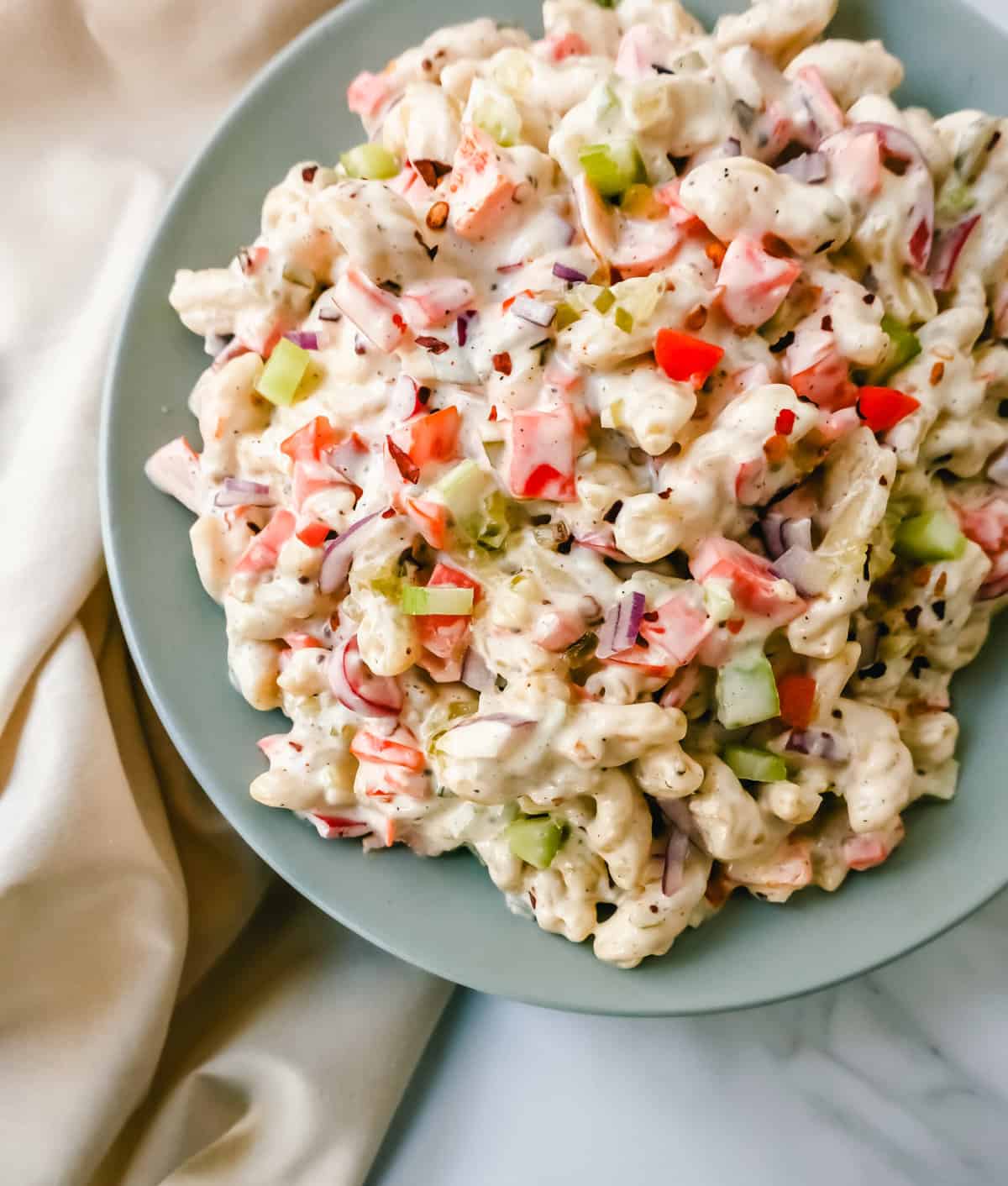 The best creamy macaroni salad recipe made with pasta, vegetables, and a creamy homemade sweet and tangy dressing. An easy, traditional macaroni salad recipe!