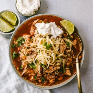 This Ranch Chicken Chili is a quick and easy soup recipe made with shredded chicken, onion, garlic, chili powder, green chilies, white beans, ranch powder, and topped with cheese and sour cream.