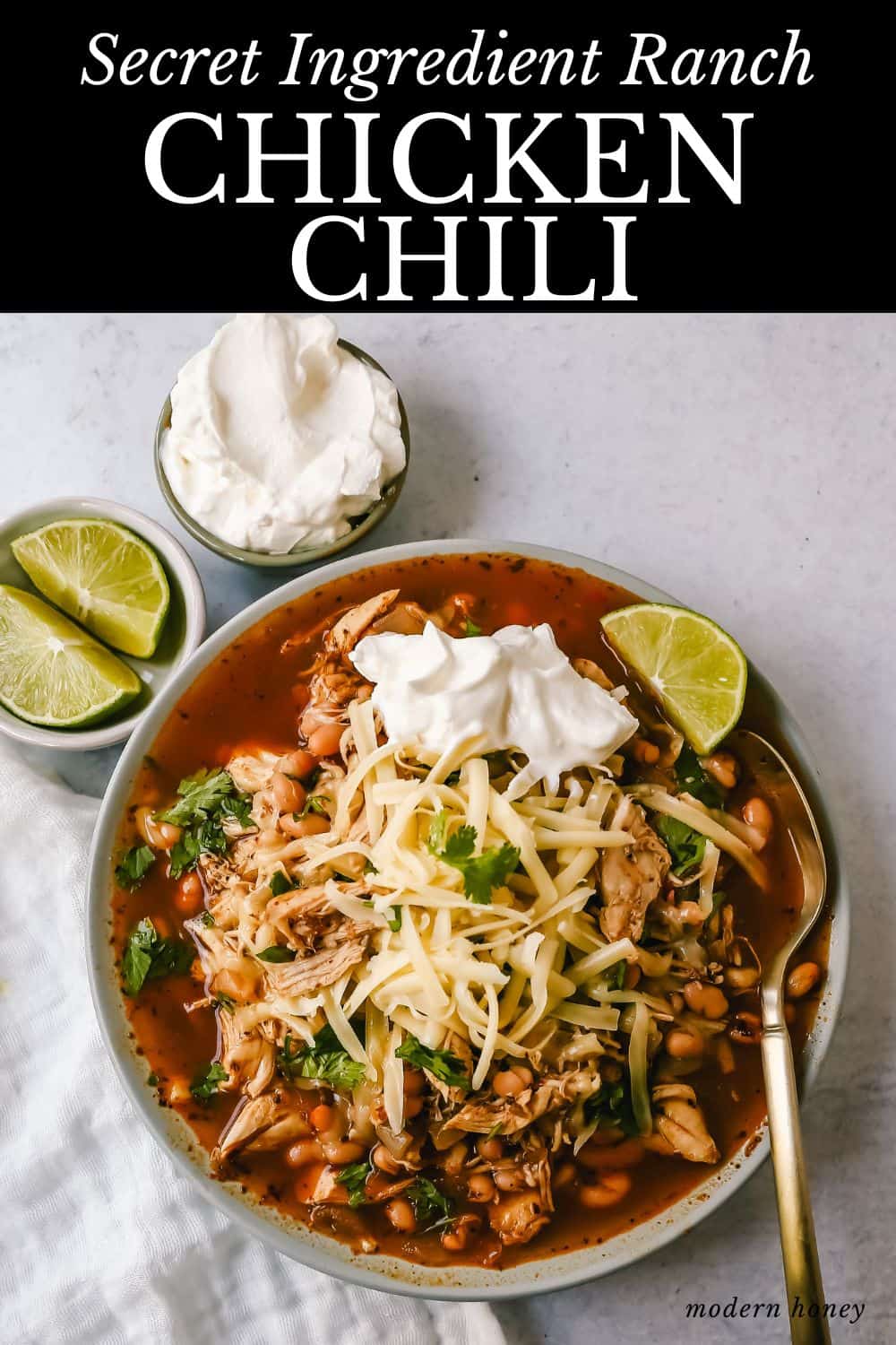 This quick and easy chicken chili is made in less than 30 minutes and filled with protein, good fats, and healthy carbs! This White Chicken Chili is a quick and easy soup recipe made with shredded chicken, onion, garlic, chili powder, green chilies, white beans, and ranch powder, and topped with cheese and sour cream.