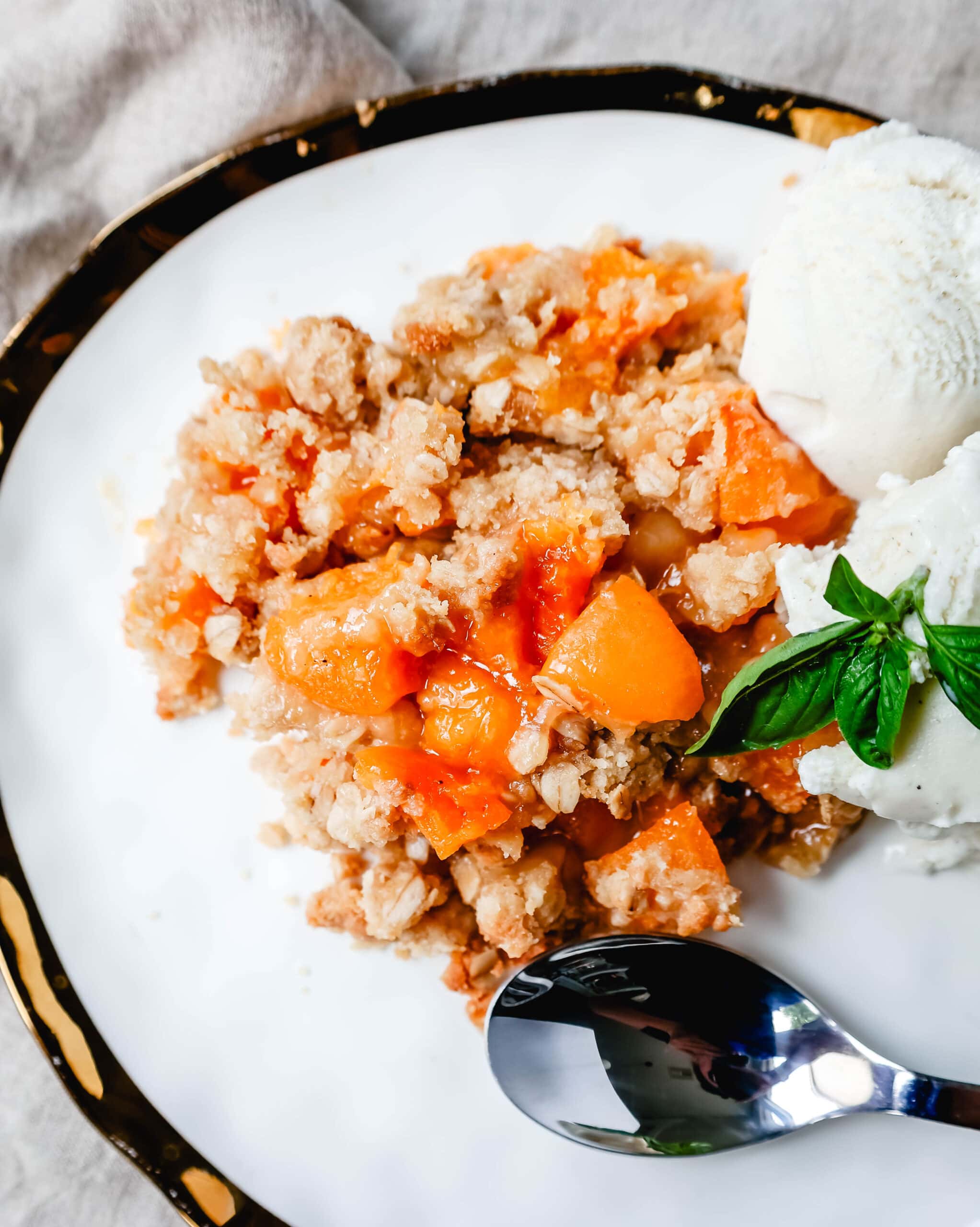 This Apricot Crisp is made with fresh apricots tossed in sugar and almond extract and topped with a homemade brown sugar oat crumble. This rustic summer dessert is served with a big scoop of vanilla bean ice cream. 