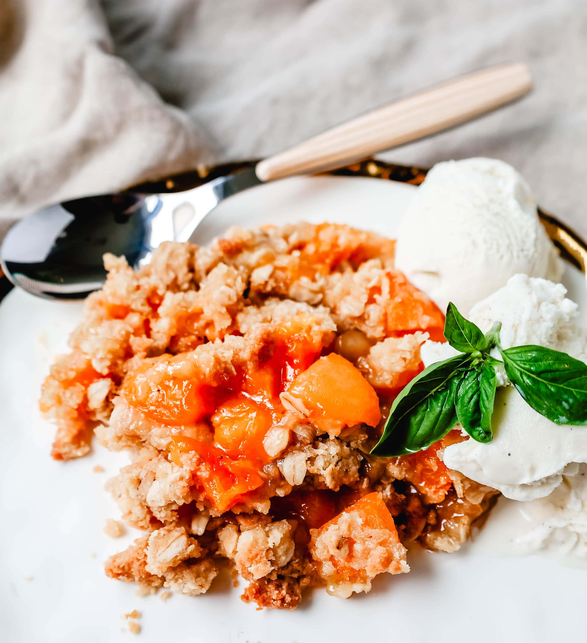 This Apricot Crisp is made with fresh apricots tossed in sugar and almond extract and topped with a homemade brown sugar oat crumble. This rustic summer dessert is served with a big scoop of vanilla bean ice cream. 