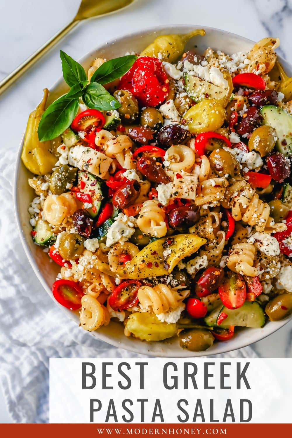 Homemade Greek Pasta Salad made with Pasta, Greek Olives, Feta Cheese, Peppers, Tomatoes, Cucumber, Pepperoncinis, and tossed in a Homemade Greek Dressing. The Best Greek Pasta Salad Recipe!