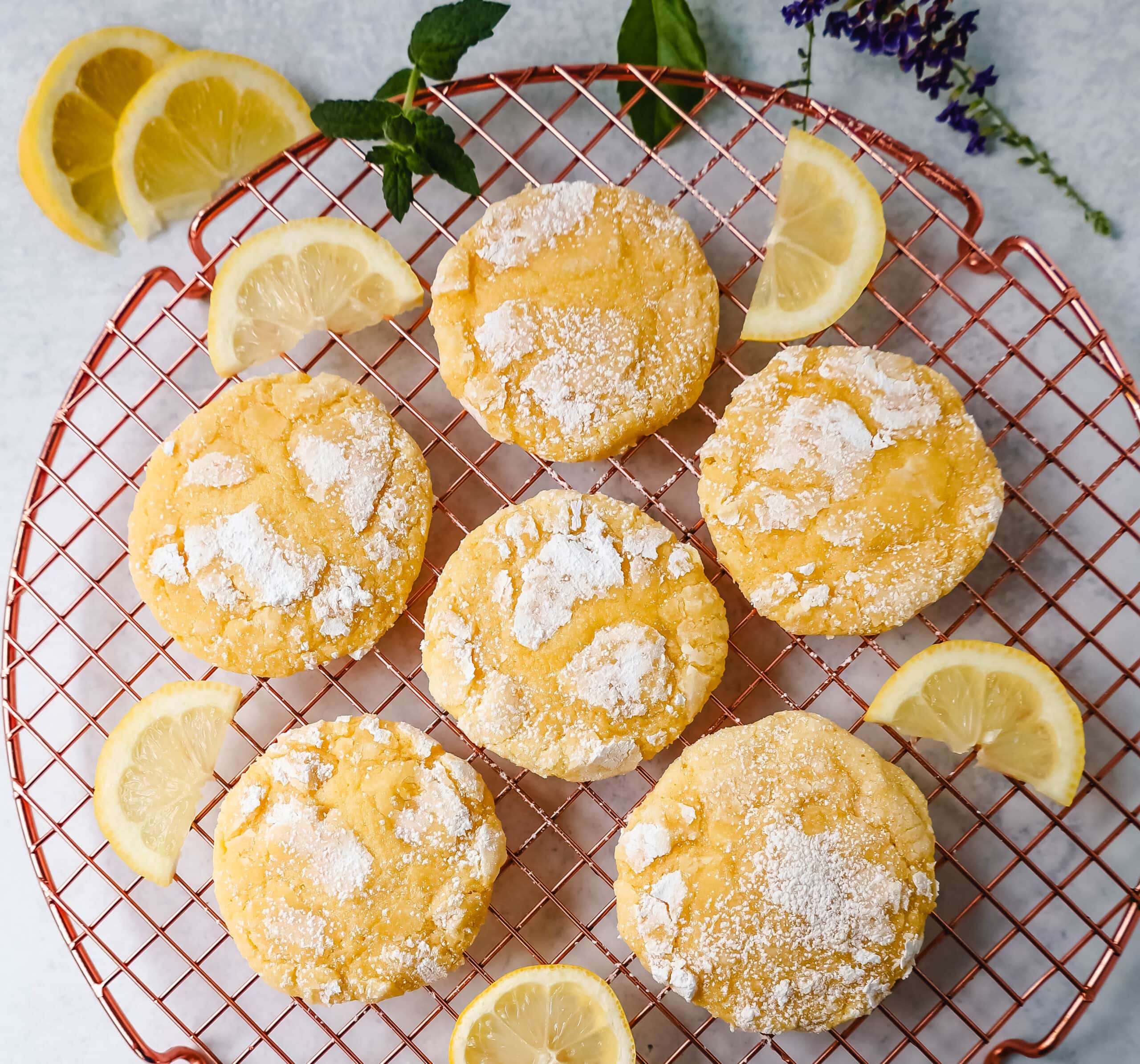 Soft chewy lemon cookies with fresh lemon juice, lemon zest, and lemon extract to give them the extra lemon tang! These lemon crinkle cookies are rolled in powdered sugar and baked until soft and chewy. The best lemon cookie recipe!