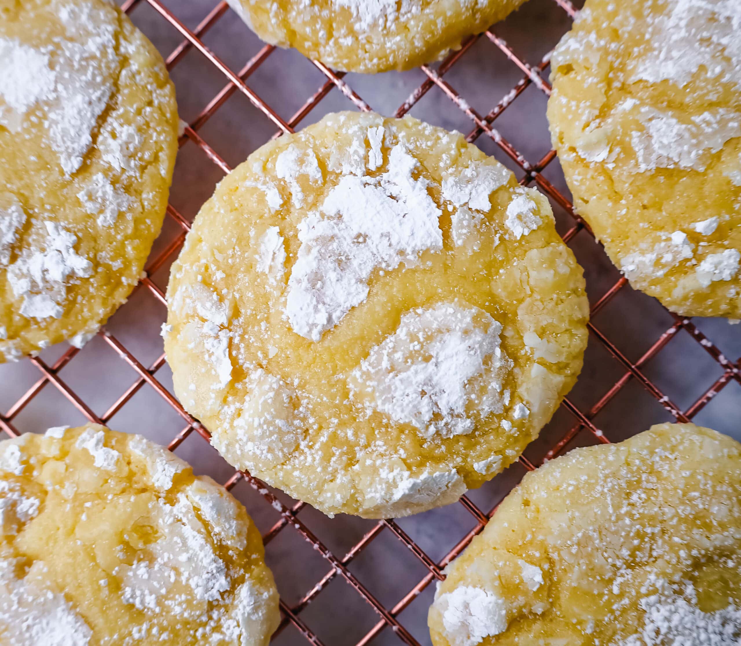 Soft chewy lemon cookies with fresh lemon juice, lemon zest, and lemon extract to give them the extra lemon tang! These lemon crinkle cookies are rolled in powdered sugar and baked until soft and chewy. The best lemon cookie recipe!