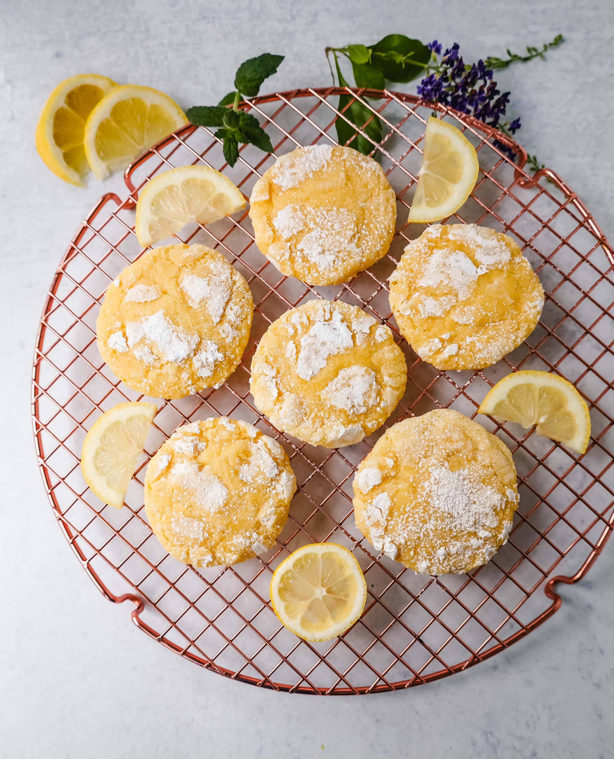 Soft chewy lemon cookies with fresh lemon juice, lemon zest, and lemon extract to give them the extra lemon tang! These lemon crinkle cookies are rolled in powdered sugar and baked until soft and chewy. The best lemon cookie recipe!