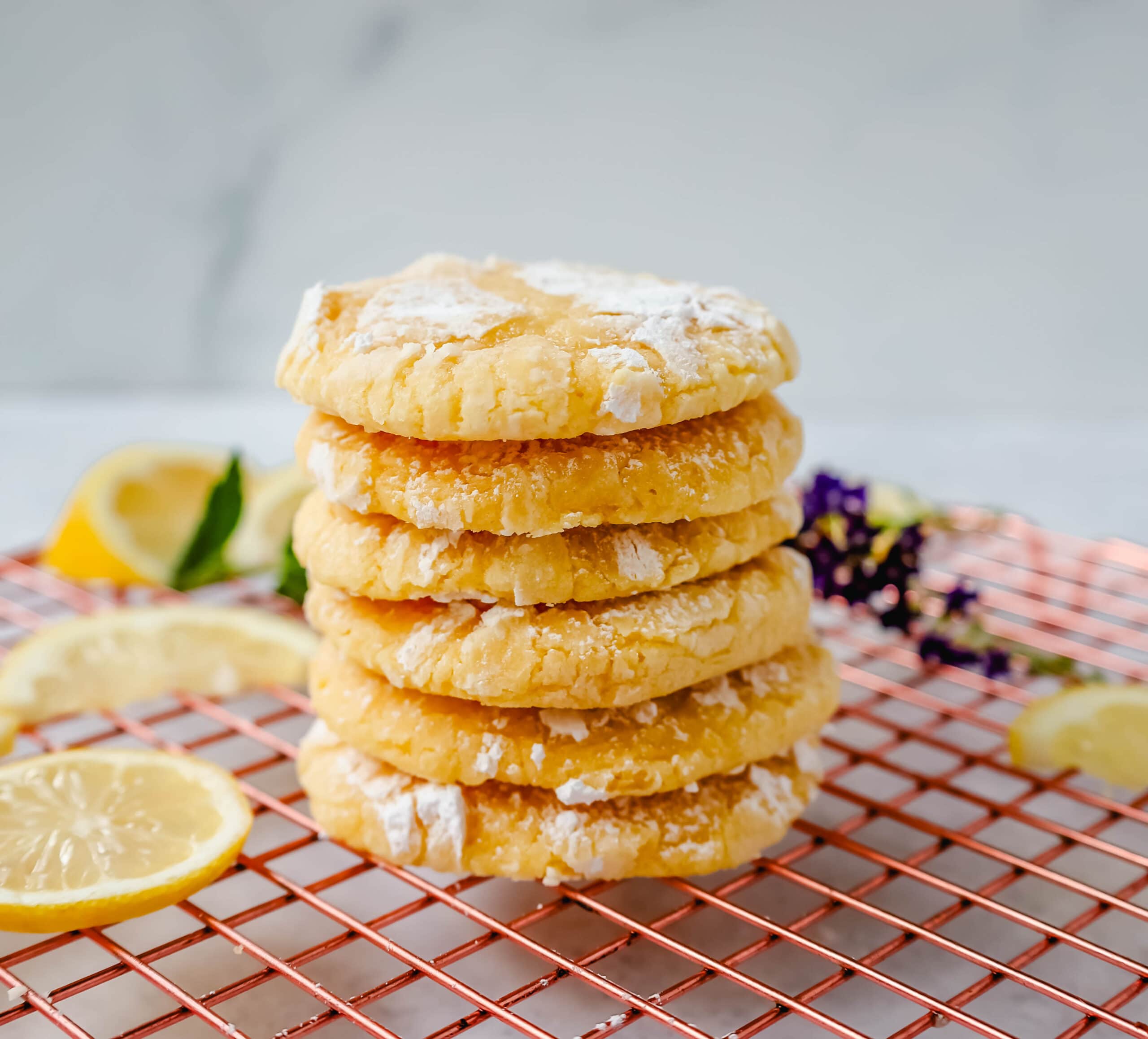 Soft chewy lemon cookies with fresh lemon juice, lemon zest, and lemon extract to give them the extra lemon tang! These lemon crinkle cookies are rolled in powdered sugar and baked until soft and chewy. The best lemon cookie recipe!