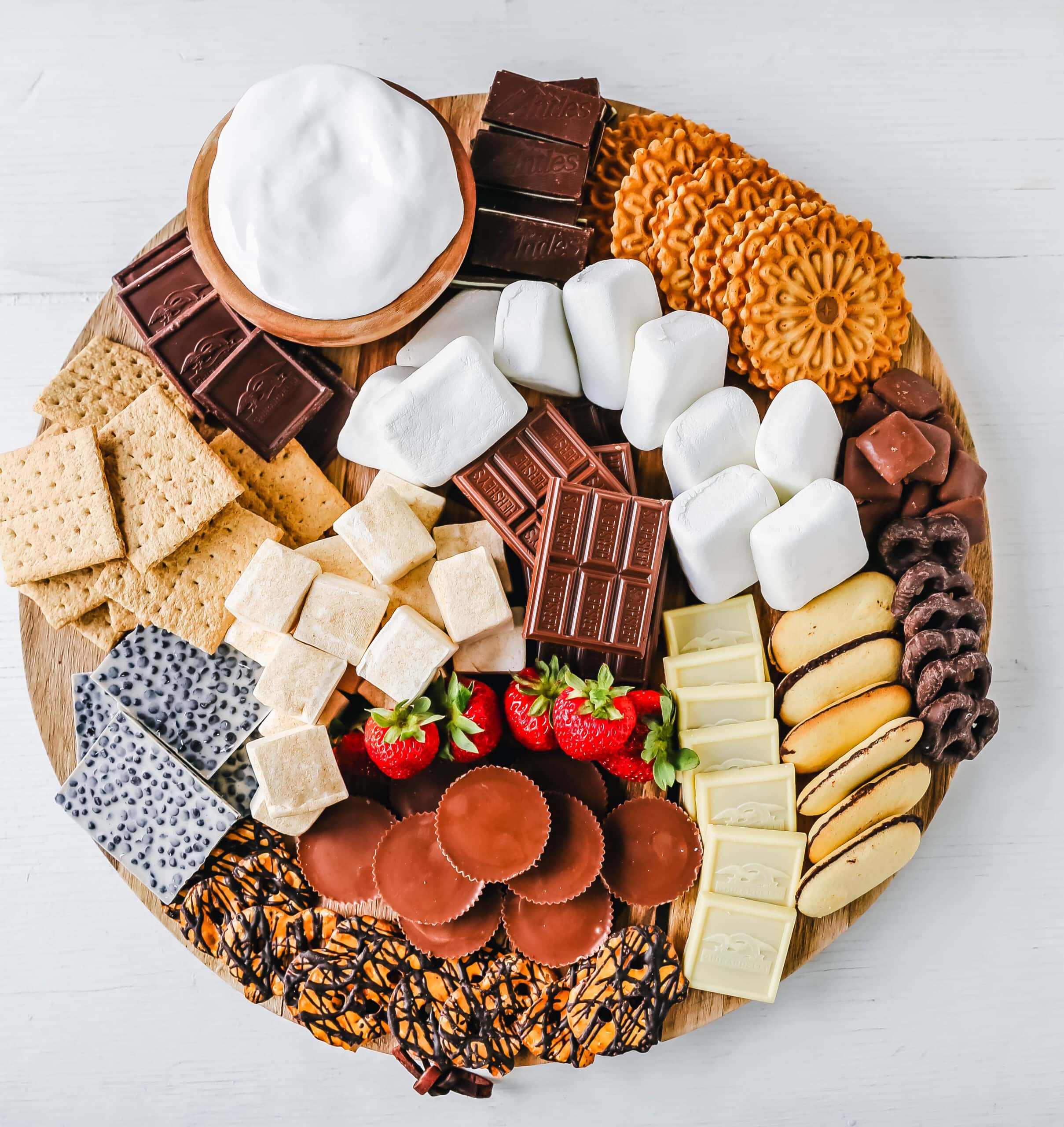 How to make the Ultimate S'mores. How to create a fun S'mores Board with all of the toppings. Perfect for campfires in the mountains, at the beach, or in your backyard! S'mores are the perfect customizable summer treat.