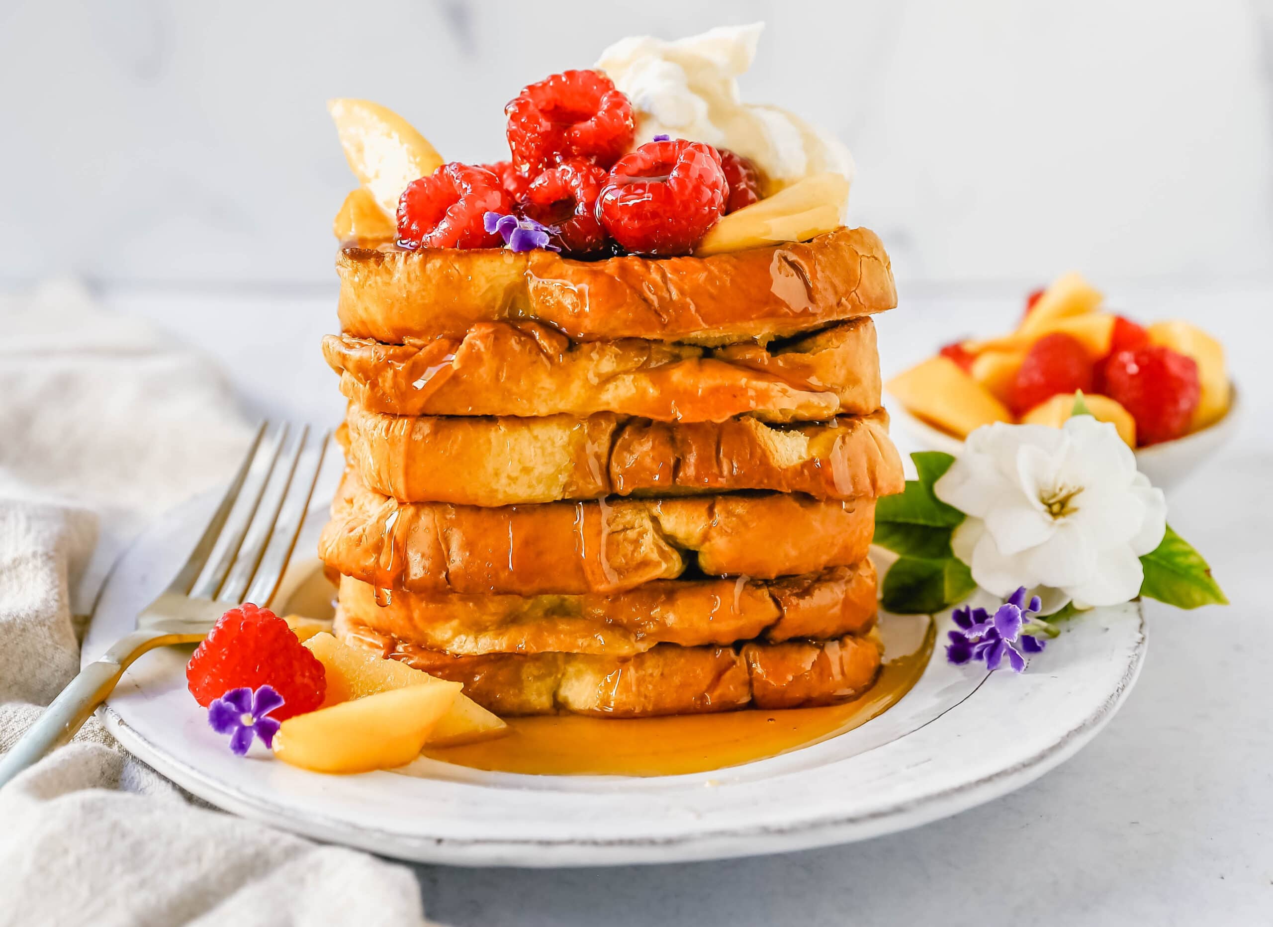 Easy Sheet Pan French Toast is made by dipping the bread into a custard batter and baking on a sheet pan in the oven. It makes it so much easier to make homemade french toast! Top this Oven Baked French Toast with a sweet Mascarpone Cream and Sweetened Fresh Fruit.