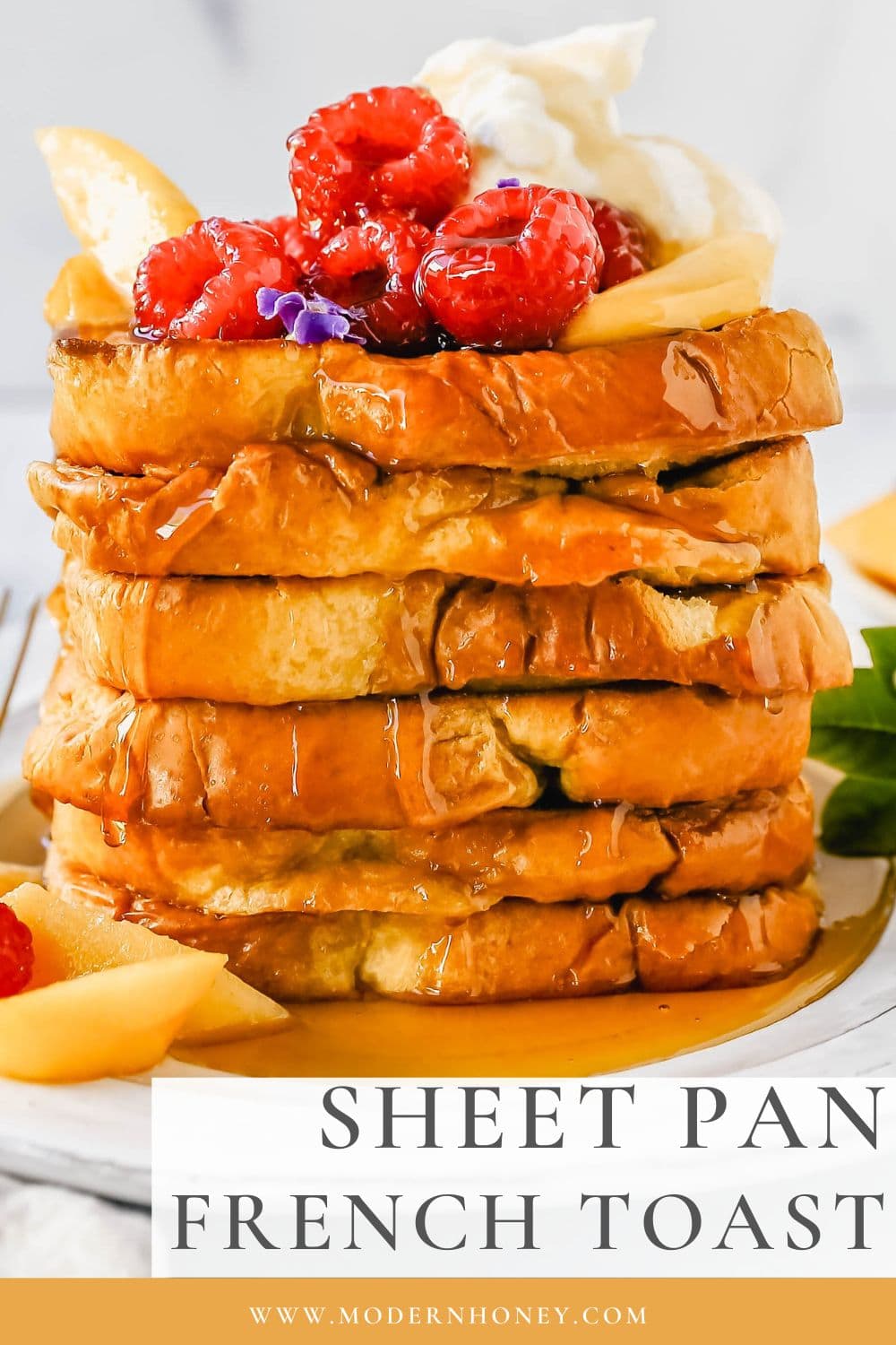 Easy Sheet Pan French Toast is made by dipping the bread into a custard batter and baking on a sheet pan in the oven. It makes it so much easier to make homemade french toast! Top this Oven Baked French Toast with a sweet Mascarpone Cream and Sweetened Fresh Fruit.