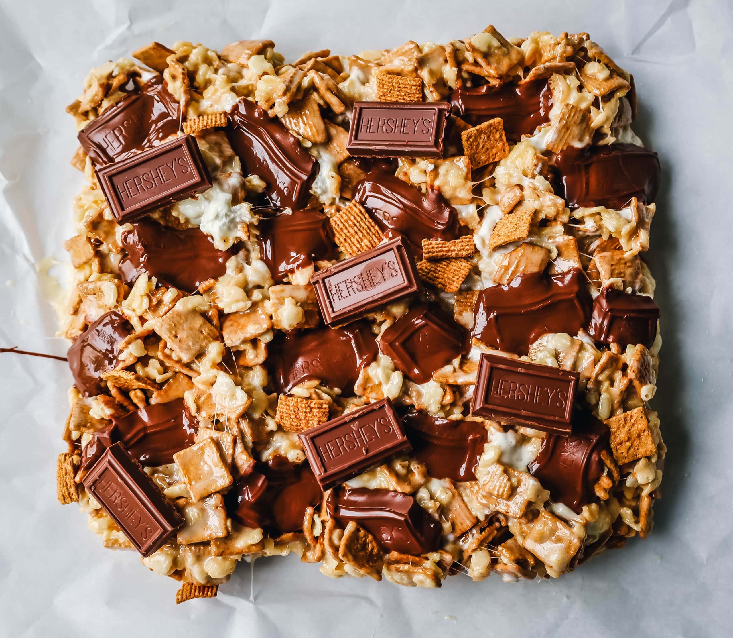 S'more Rice Krispie Treats made with Golden Graham, Rice Krispies, Marshmallows, Butter, and Hershey's Milk Chocolate Bars. The perfect S'more Rice Krispies that can be made in less than 15 minutes!