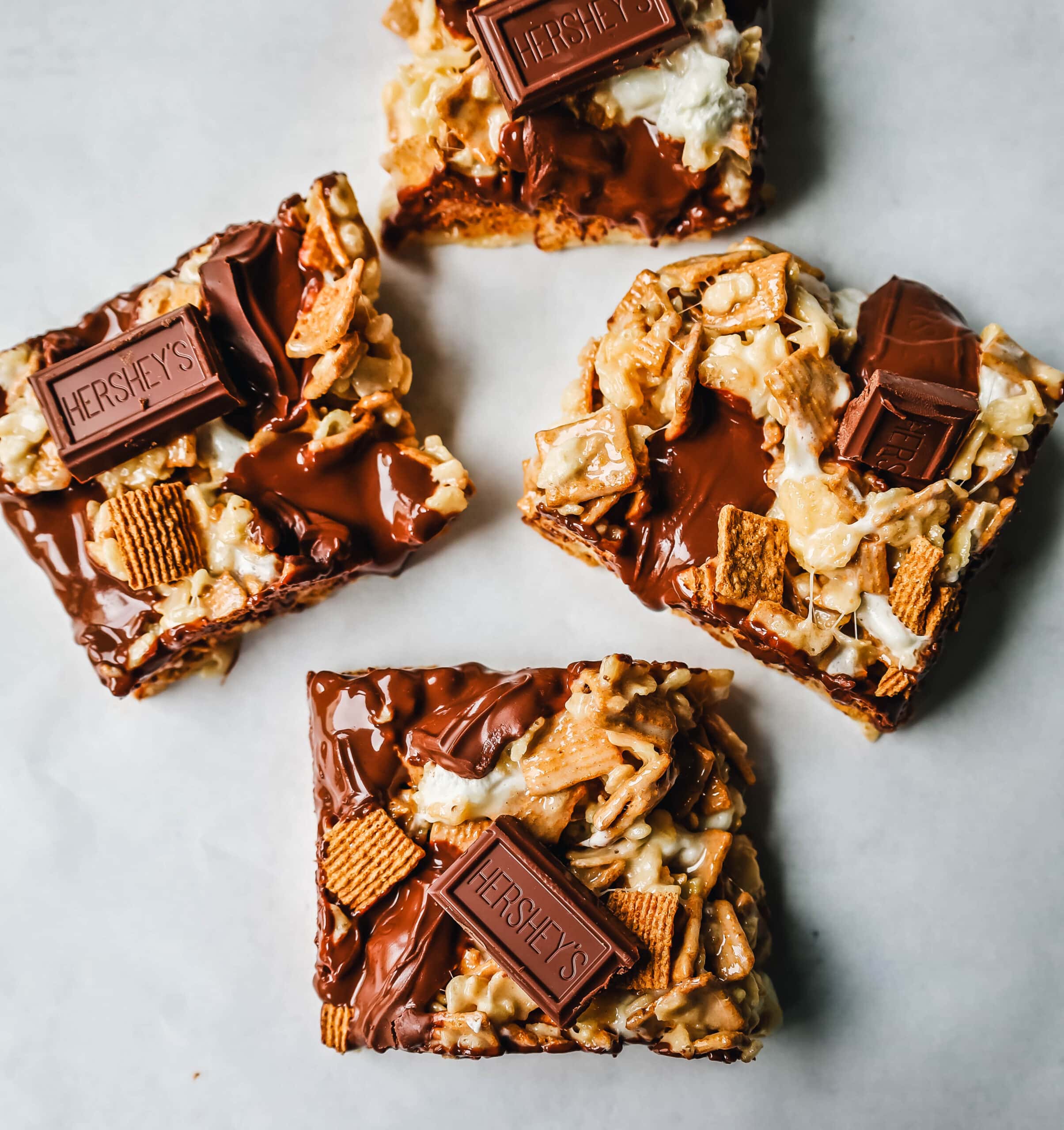 S'more Rice Krispie Treats made with Golden Graham, Rice Krispies, Marshmallows, Butter, and Hershey's Milk Chocolate Bars. The perfect S'more Rice Krispies that can be made in less than 15 minutes!